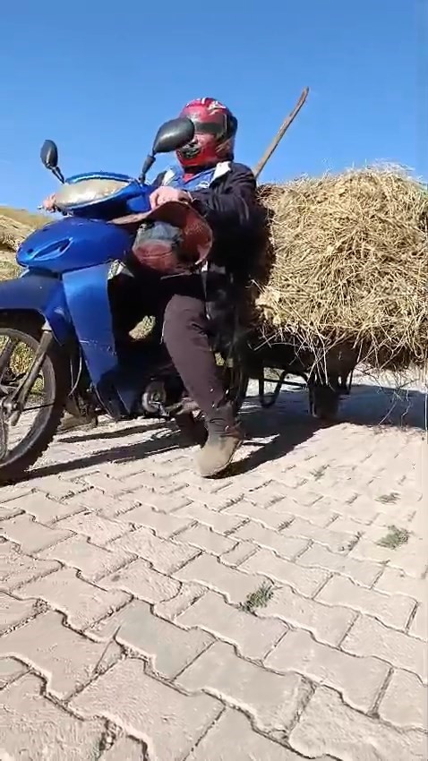 YÜKSEKOVALI VATANDAŞIN PRATİK ZEKASI: MOTOSİKLETİN ARKASINA EL ARABASI BAĞLAYARAK ÜZERİNDE OT TAŞIDI